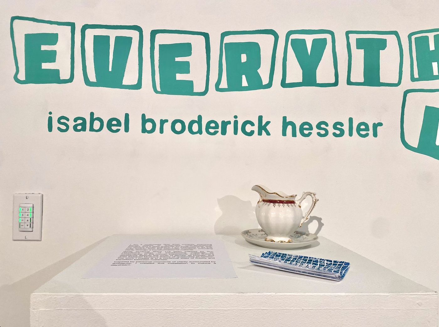 Performance in gallery, figure with teacup through vinyl