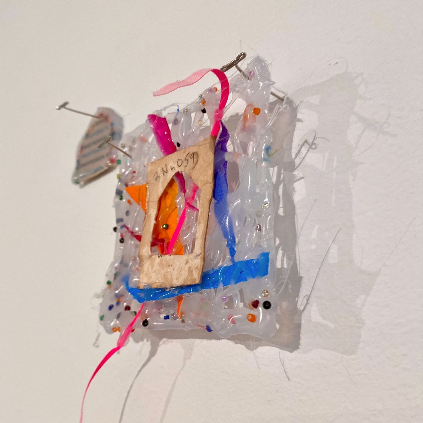 Performance, figure seen through vinyl panel with teacup