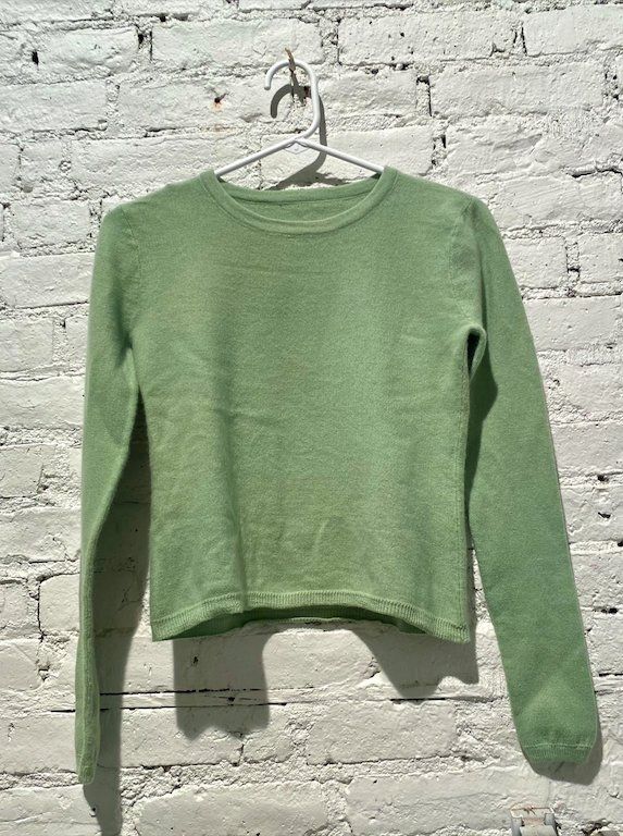 Severance mint green sweater on hanger